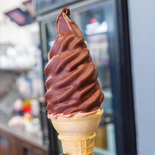 A Frosty King chocolate-dipped soft-serve ice cream cone with a waffle cone.